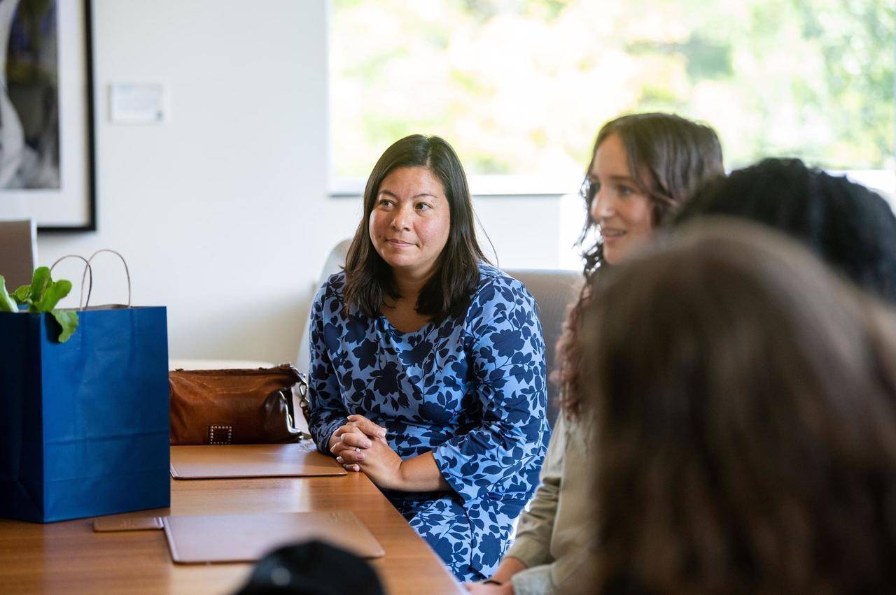 Yumi Jakobcic listening at a meeting table